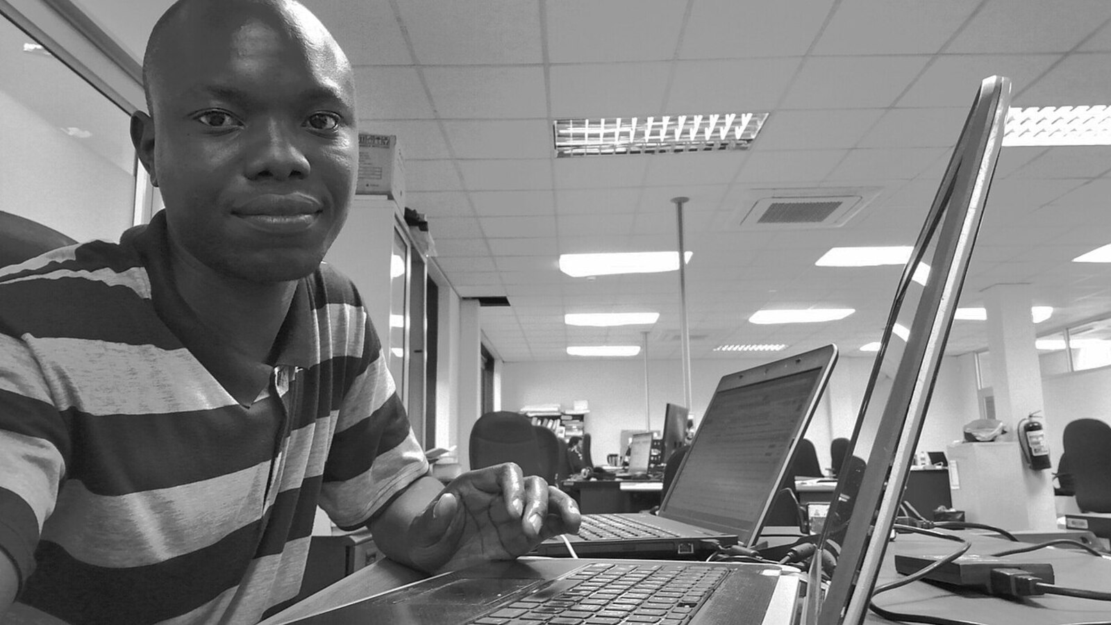 Software developer seated at a laptop workstation