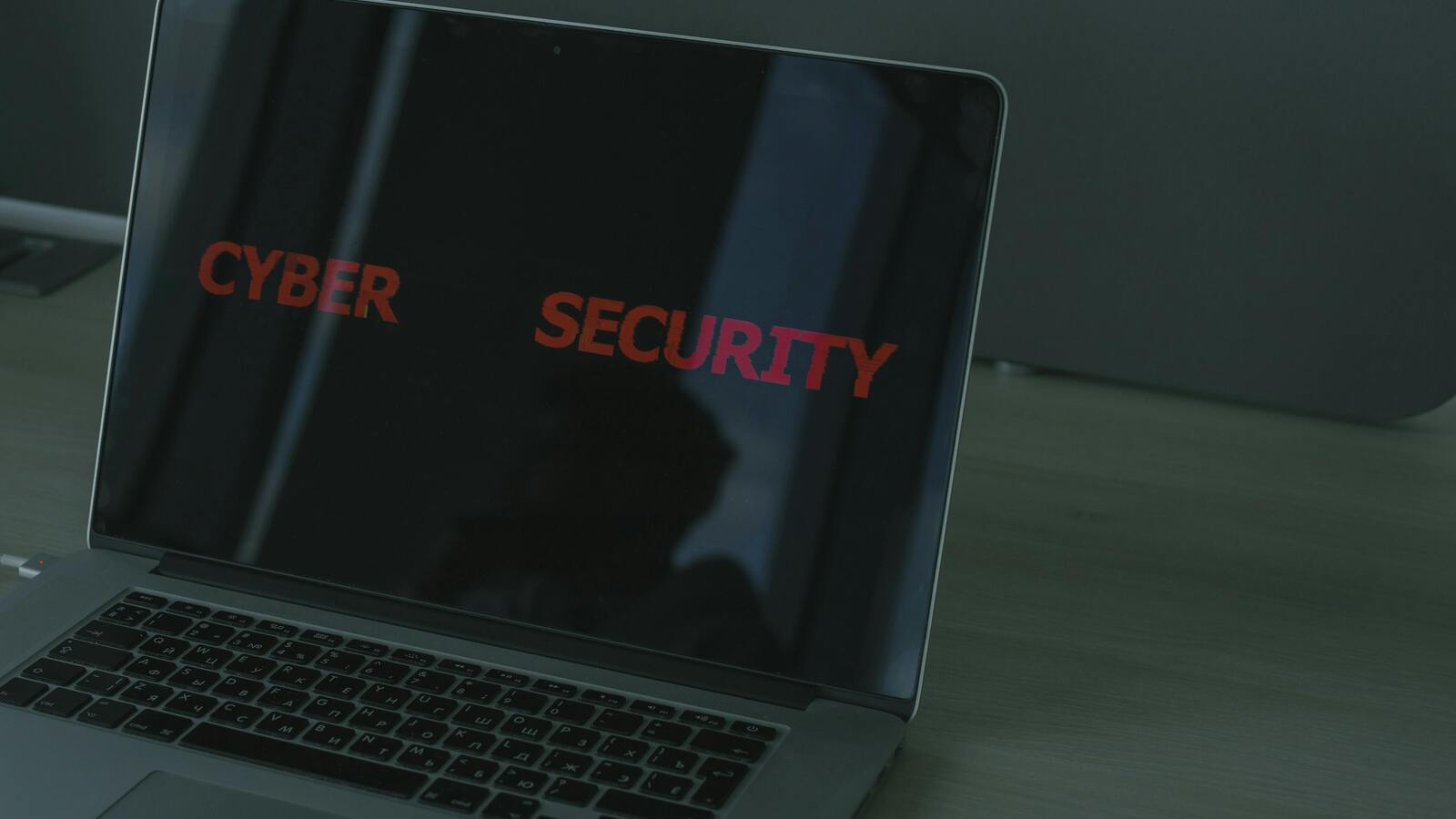 Laptop screen displaying cyber security text, representing provider trust and AI cyber model risk
