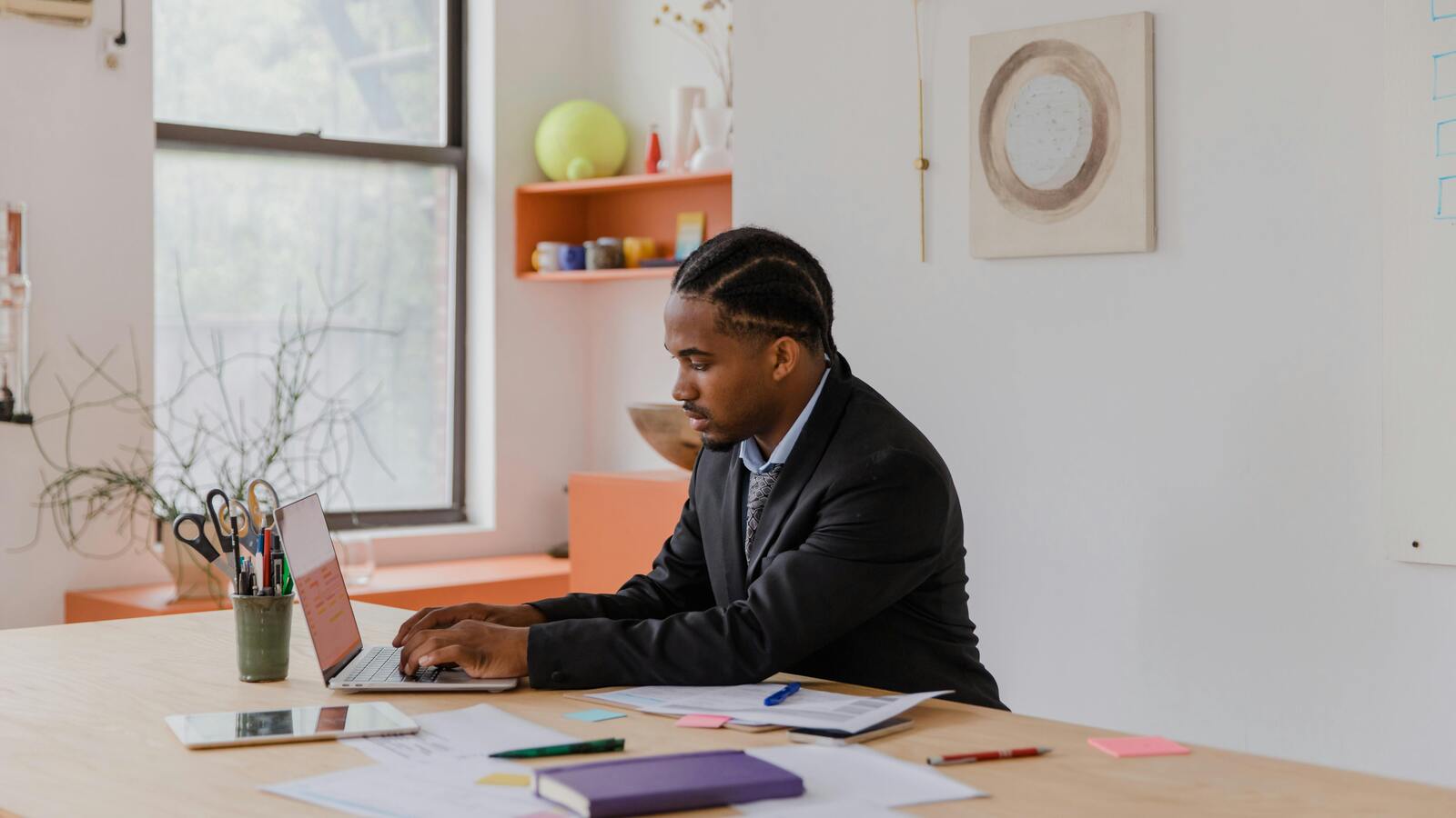 Person working on a laptop in an office, representing AI SaaS OAuth access to enterprise systems