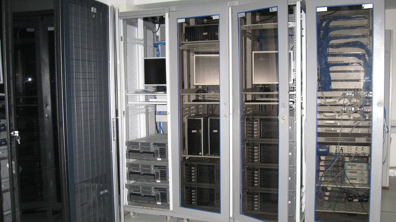 Server room aisle filled with racks and blinking equipment
