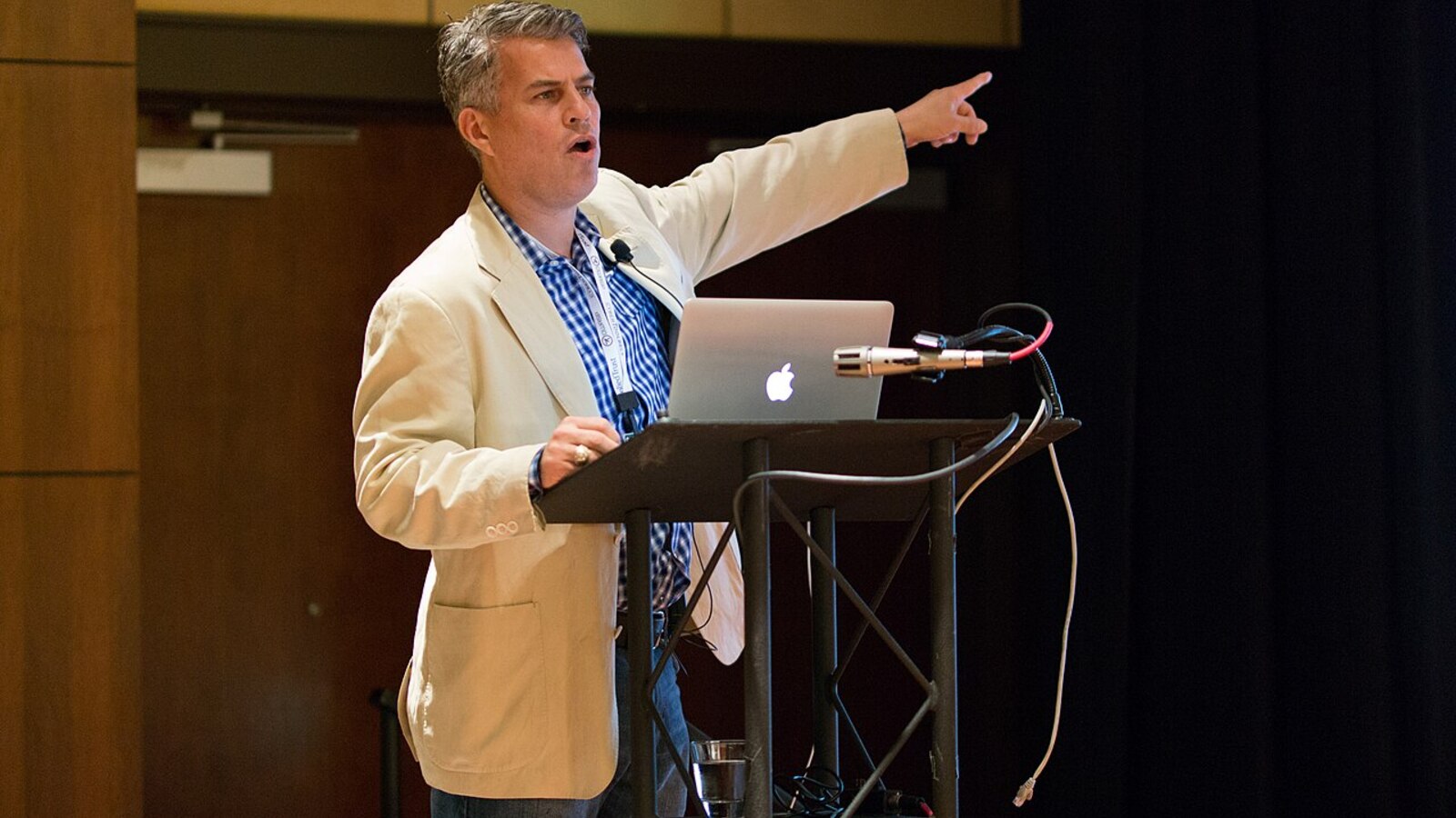 Speaker presenting at an OWASP AppSec conference podium