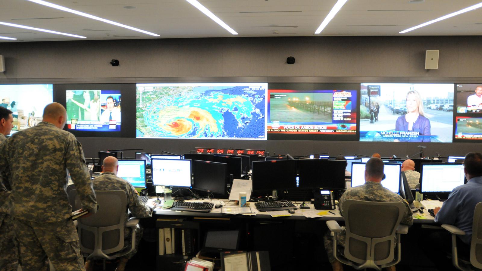 National Guard command center with operators monitoring multiple screens
